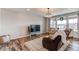 Cozy living room with hardwood floors, a comfy couch, and large windows for natural light at 17046 Desert Wine Trl, Parker, CO 80134