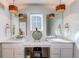 Well-lit main bathroom with double sinks, ample counter space, and modern fixtures, creating a spa-like retreat at 17046 Desert Wine Trl, Parker, CO 80134