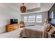 Bright, stylish main bedroom featuring natural lighting, neutral tones, and minimalist furnishings at 17046 Desert Wine Trl, Parker, CO 80134