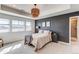 Inviting main bedroom featuring large windows, soft lighting, and serene gray accent wall at 17046 Desert Wine Trl, Parker, CO 80134