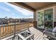 Outdoor patio featuring a fire pit, partial brick wall, sliding glass doors, and a lush green backyard at 17046 Desert Wine Trl, Parker, CO 80134