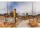 Community playground with swings, slides, and climbing features for outdoor fun and recreation at 17046 Desert Wine Trl, Parker, CO 80134