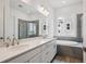 Bathroom features double vanity, a soaking tub, and a glass-enclosed shower with tile surround at 9197 Ironwood St, Highlands Ranch, CO 80129