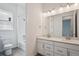Bright bathroom with dual sinks, large mirror, and a tub and shower combination at 9197 Ironwood St, Highlands Ranch, CO 80129