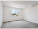 Bedroom with a window providing natural light and neutral carpeting at 9197 Ironwood St, Highlands Ranch, CO 80129