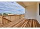 This covered deck features wood flooring and railings, offering outdoor living space at 9197 Ironwood St, Highlands Ranch, CO 80129