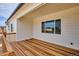 Covered deck boasts wood flooring and railings, providing a private space for outdoor living at 9197 Ironwood St, Highlands Ranch, CO 80129