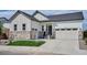 Inviting home exterior boasts stone accents, tidy lawn, and two-car garage at 9197 Ironwood St, Highlands Ranch, CO 80129