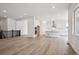 Open kitchen and living area, with modern white cabinets and stainless appliances at 9197 Ironwood St, Highlands Ranch, CO 80129