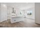 Bright kitchen with island, white cabinets, and modern stainless range hood at 9197 Ironwood St, Highlands Ranch, CO 80129