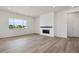Bright living room with light wood floors and modern fireplace at 9197 Ironwood St, Highlands Ranch, CO 80129