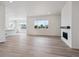 Open-concept living room boasts wood floors and a modern fireplace at 9197 Ironwood St, Highlands Ranch, CO 80129