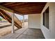 Covered patio with stairs leading to the backyard, concrete patio, and privacy wall at 9197 Ironwood St, Highlands Ranch, CO 80129