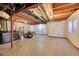 A spacious unfinished basement with exposed beams and some construction supplies at 5660 S Algonquian Way # A, Aurora, CO 80016