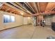A spacious unfinished basement with exposed beams and some utilities at 5660 S Algonquian Way # A, Aurora, CO 80016