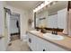 Bathroom featuring double sinks and plentiful lighting at 5660 S Algonquian Way # A, Aurora, CO 80016