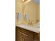 Stylish bathroom featuring a designer mirror, vanity, quartz countertop and brushed gold faucet at 5660 S Algonquian Way # A, Aurora, CO 80016