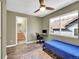This bedroom features a ceiling fan, view to the outside, and an ensuite bathroom at 5660 S Algonquian Way # A, Aurora, CO 80016