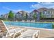 Resort-style community pool with lounge chairs and well-maintained landscaping with neighborhood homes in background at 5660 S Algonquian Way # A, Aurora, CO 80016