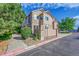Charming exterior view of multi-level homes with well-maintained landscaping on a sunny day with blue skies at 5660 S Algonquian Way # A, Aurora, CO 80016