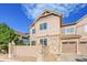 Attractive multi-level home with stone and siding exterior, attached garage, and well-kept landscaping and blue skies at 5660 S Algonquian Way # A, Aurora, CO 80016