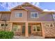 Charming townhouse with stone accents, covered entryway, neutral paint, and beautiful blue sky at 5660 S Algonquian Way # A, Aurora, CO 80016