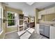Bright kitchen open to living area, featuring stainless steel appliances and light-filled windows at 5660 S Algonquian Way # A, Aurora, CO 80016