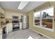 Well-lit kitchen with stainless steel appliances, ample counter space, and a large window at 5660 S Algonquian Way # A, Aurora, CO 80016