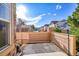 This patio features concrete, a wooden fence, and a view of nearby houses at 5660 S Algonquian Way # A, Aurora, CO 80016