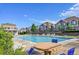 Community pool with blue water, lawn chairs, and lush greenery at 5660 S Algonquian Way # A, Aurora, CO 80016