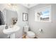 Guest bathroom with pedestal sink, toilet and window at 5245 W 97Th Ave, Broomfield, CO 80020