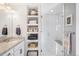 Bathroom with a walk-in shower, built-in shelves, and granite vanity at 5245 W 97Th Ave, Broomfield, CO 80020