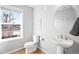 Bathroom with pedestal sink, toilet and large window at 5245 W 97Th Ave, Broomfield, CO 80020