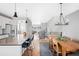 Open concept dining area with a farmhouse table and modern chandelier at 5245 W 97Th Ave, Broomfield, CO 80020