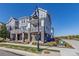 Modern 3-story townhome with gray siding, stone accents, and a balcony at 5245 W 97Th Ave, Broomfield, CO 80020