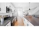 Modern kitchen featuring stainless steel appliances and white cabinetry at 5245 W 97Th Ave, Broomfield, CO 80020