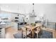 Open concept kitchen with island, white cabinets, and hardwood floors at 5245 W 97Th Ave, Broomfield, CO 80020