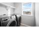 Laundry room with washer, dryer and overhead shelving at 5245 W 97Th Ave, Broomfield, CO 80020