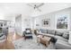 Spacious living room with gray sectional sofa, fireplace, and large windows at 5245 W 97Th Ave, Broomfield, CO 80020