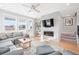 Living room boasts a fireplace, large windows and hardwood floors at 5245 W 97Th Ave, Broomfield, CO 80020