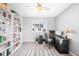 Spacious home office with a large desk and built-in bookshelves at 5245 W 97Th Ave, Broomfield, CO 80020