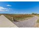 Paved path next to a grassy field and wooden fence at 5245 W 97Th Ave, Broomfield, CO 80020