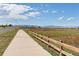 Paved path with mountain views and a wooden fence at 5245 W 97Th Ave, Broomfield, CO 80020