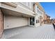 Covered back patio with a fan, sliding glass doors, and outdoor fireplace feature at 6854 Carr St, Arvada, CO 80004