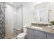 Modern bathroom with a glass-enclosed shower, a neutral color palette and a gray countertop vanity at 6854 Carr St, Arvada, CO 80004