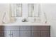 Elegant bathroom featuring a double vanity with granite countertops and modern fixtures at 6854 Carr St, Arvada, CO 80004