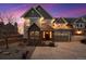 Charming two-story home with brick and gray siding and an attached two-car garage, captured during a vibrant sunset at 6854 Carr St, Arvada, CO 80004