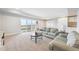 Comfortable living room with light gray sofas and neutral decor, with a sliding door to the backyard at 6854 Carr St, Arvada, CO 80004