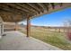 Expansive covered patio offers a seamless transition to a serene, fenced backyard with views at 6854 Carr St, Arvada, CO 80004