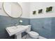 Stylish powder room featuring tiled walls, a vessel sink and decor at 6854 Carr St, Arvada, CO 80004